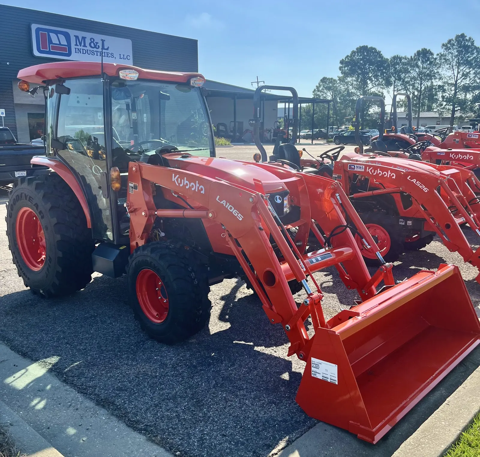 Orange Kubota tractor with front loader on the M&L Industries lot in Baton Rouge